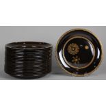 (lot of 20) Japanese black lacquered plates, the center with three stylized medaillions, the rim and