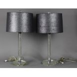 Modern acrylic table lamps, each having a cylindrical standard, rising on a circular base, 27"h