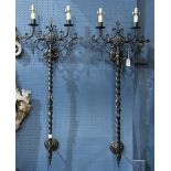 Pair of large Spanish Revival wall sconces, each having two lights surmounting the scroll and