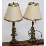 (lot of 2) Brass candlestick table lamps, each having a single light and rising on a turned standard