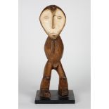 Stylized and abstract standing wood figure, carved for use by the Bwami Society, Lega people, D.