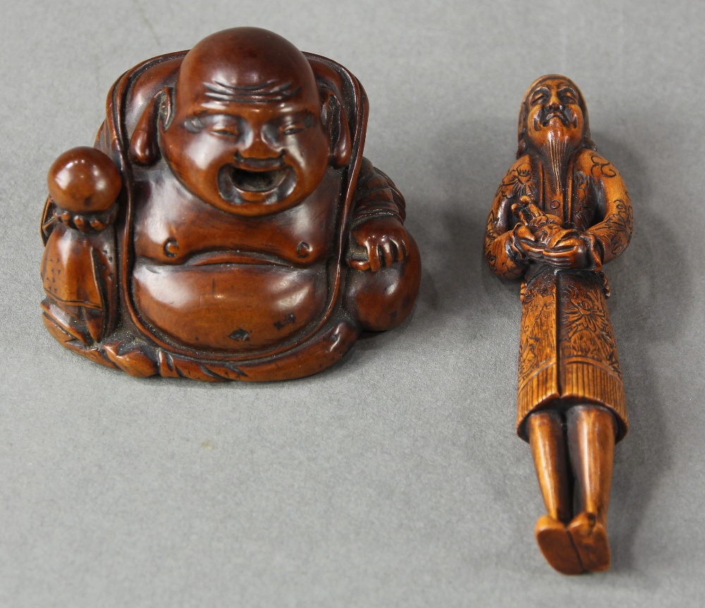 (lot of 2) Japanese wood netsuke: a happy Hotei with a jewel; together with a foreigner with a doll,