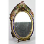 Italian porcelain vanity mirror, having a sculpted rocaille crest with applied floral accents and