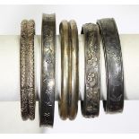 (Lot of 5) Silver and metal bracelets comprised of one thick silver flower engraved cuff bracelet,