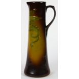 Weller Louwelsa art pottery ewer, having a spouted rim and handle, the cylindrical form with a