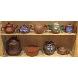 (lot of 9) Two shelves of zisha teapots, including three decorated with enamel; together with a