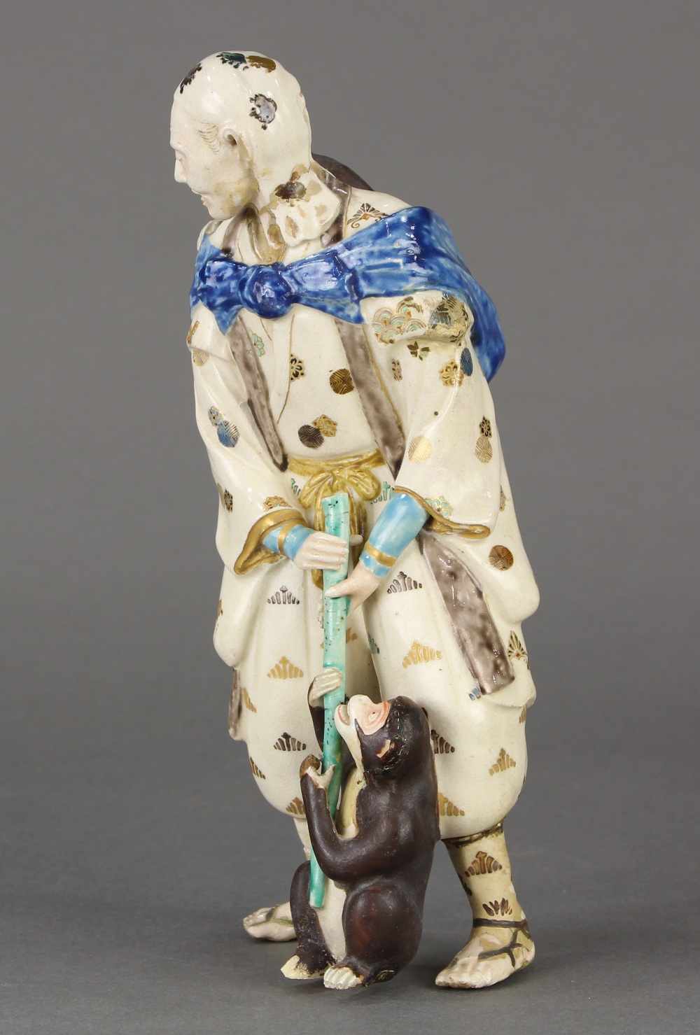 Japanese Satsuma ceramic figure, of a travelling entertainer with a bundle and a monkey on his - Image 2 of 12