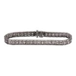 Diamond and platinum straightline bracelet featuring (41) older, full-cut diamonds, weighing a total