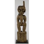 Figural post, Bahau, Dayak, Indonesia, the figure having round eyes, big bared teeth, and some