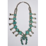 Turquoise and silver squash blossom necklace centering a Naja, accented by (11) irregular