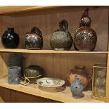 (lot of 11) Two shelves of Asian ceramics, mostly of jars and vases with a dark glaze, a slip