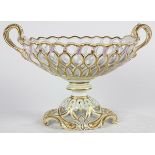 Continental porcelain compote, having a reticulated body with partial gilt accents, and rising on