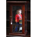 (lot of 2) Porcelain doll of a drummer, housed in a table top vitrine, circa 1880, case: 32"h