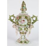 Continental porcelain lidded urn, the baluster form with floral finial flanked by foliate form