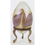 Art glass egg, having pulled feather motifs on a white opalescent ground, rising on a bronze