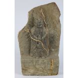 Asian stone figural carving, of a deity standing on a floral plinth with hands clasped to the front,