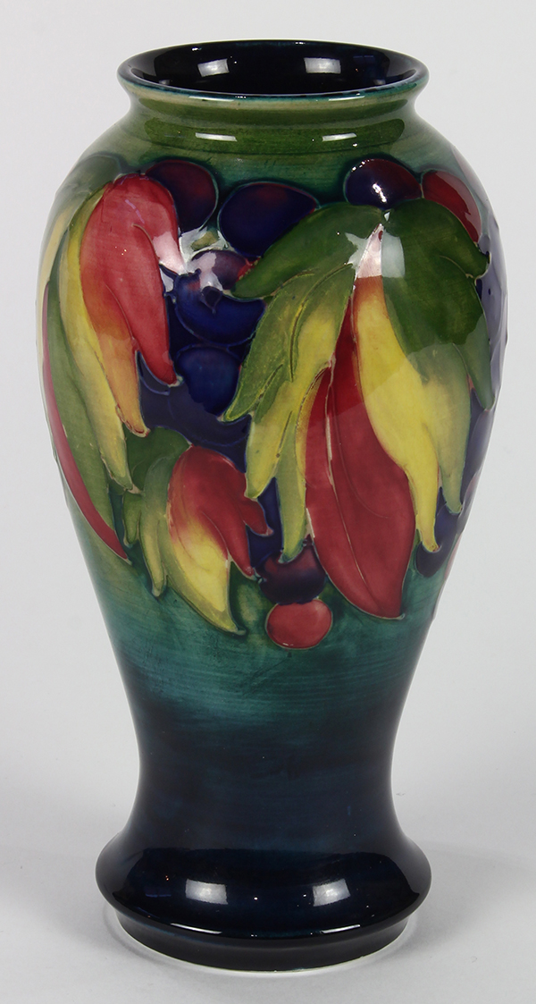 Moorcroft flambe vase, circa 1925, the baluster form depicting leaves and berries on a cobalt