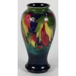 Moorcroft flambe vase, circa 1925, the baluster form depicting leaves and berries on a cobalt