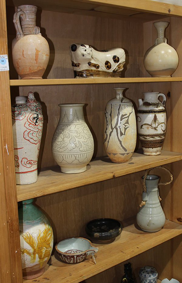 (lot of 11) Three shelves of Chinese ceramics, including a Cizhou type pillow and vases; a green and