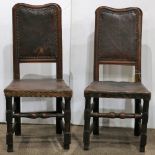 Pair of Continental hallchairs, 18th century, each with a shaped crestrail over a brown leather back