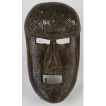 Sukuma, Tanzania, powerful art brut mask of heavy wood with a square mouth having one iron tooth,