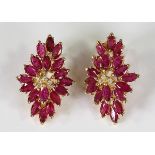 Pair of Ruby, diamond and yellow gold earrings featuring (36) marquise-cut rubies, weighing a
