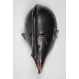 Elegant and dramatic bird mask with down-curving beak, Koulango, Cote d'Ivoire, finely carved from a