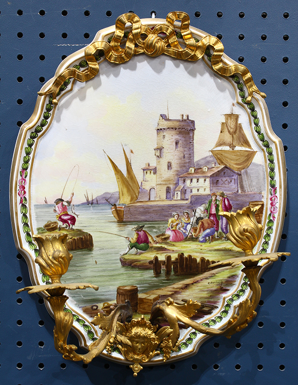 French porcelain wall sconce, the crest form plaque depicting a port scene, signed "E. Ducrocq",