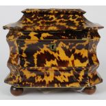 English Casket form tea caddy, having faux tortoise shell veneer, the hinged lid opening to a fitted