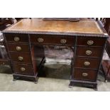 Regency style kneehole desk, the rectangular top with inset tooled leather writing surface,