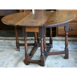 William and Mary style drop leaf table, circa 1800, executed in oak, having an oval top with two