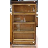 Quartersawn oak lawyer's bookcase, having four shelves each with hinged front glass panel doors,