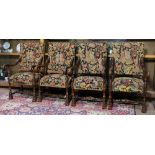 (lot of 4) Jacobean style carved oak arm chairs, each having a needlepoint upholstered seat and