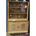 Mid Century bleached oak hutch circa 1960, with glass doors above the two-door case, having carved