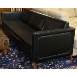 Mid Century black upholstered sofa, having a square profile, and rising on tapered legs, 25.5"h x