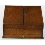 Quartersawn oak document file, the slanted hinged front opening to a fitted interior with narrow