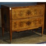 Continental inlaid chest of drawers, circa 1820, the two drawer case rising on tapering legs, 36"h x