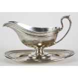 Marcus & Company sterling silver sauce boat and stand, each engraved with floral swags and bows