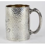 Dominick & Haff sterling silver hand-hammered mug fronted by a stylized monogram, dated 1882, 3.75"