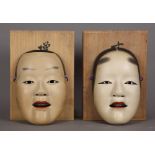 (Lot of 2) Japanese wooden Noh masks: with eyes, mouth, nostrils pierced, black lacquered