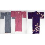 (lot of 3) Japanese silk kimono: the first mauve colored with floral motif; the second colorful