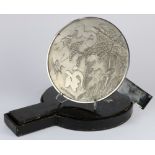 Japanese handled mirror in black lacquered case, cast with cranes, a turtle, pines and bamboo,