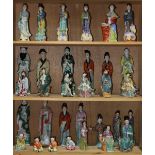 (lot of approx. 32) Three shelves of Chinese porcelain figures, including immortals, beauties and