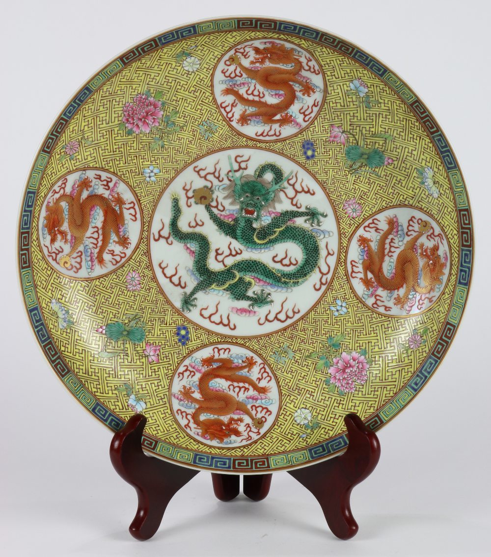 Chinese enameled porcelain plate, featuring five dragon roundels on a yellow ground with wanzi