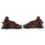 Pair of Chinese wood sculptures, each of Liu Hai in a reclining position holding a strand of coins