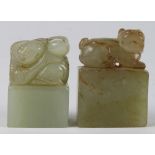(lot of 2) Chinese hardstone seals, one of a recumbent dog; the other of a child with a peach