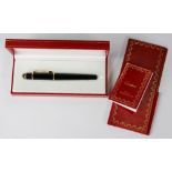 Cartier Diablo pen the 3 piece clack and gold tone roller ball pen, measures approximately 5 1/2 X