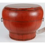 Chinese red lacquered wood container, with wide shoulders and a tapering body flanked by handles,