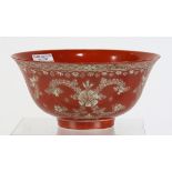 Chinese coral red reverse decorated porcelain bowl, featuring floral sprigs and garlands, base