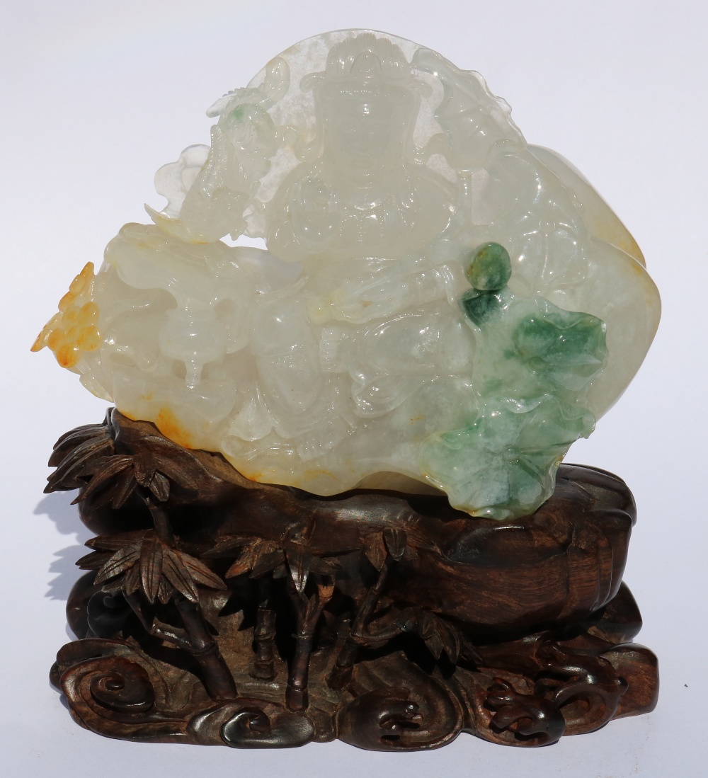 Chinese jadeite figural carving, featuring Guanyin seated in royal ease, holding a jewel and lotus